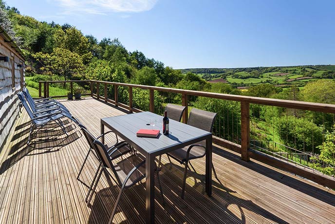 The incredible terrace at dog-friendly property Larch Barn, which looks out over the rolling East Devon countryside