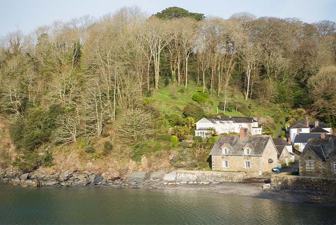 Looking across the water at the pretty village of Durgan with a little shingle beach below