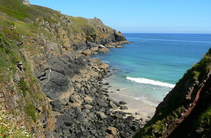 Looking down the cliffs at the rocky cove at Housel Bay in West Cornwall