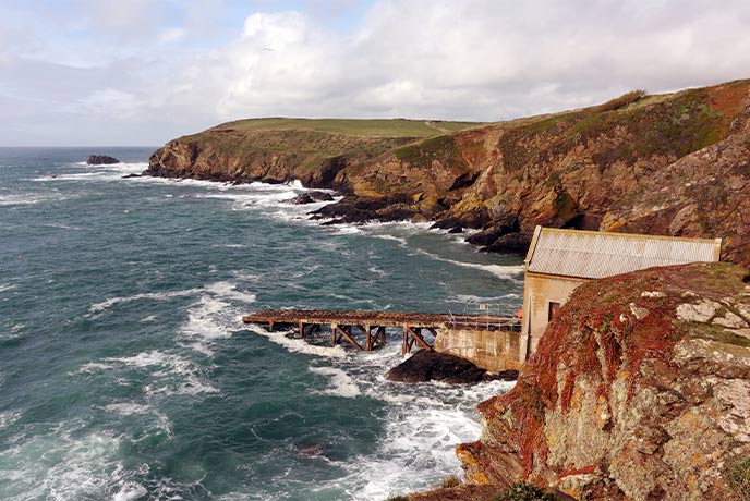 Looking down the cliffs at the lifeboat station at Polpeor Cove on the Lizard Peninsula