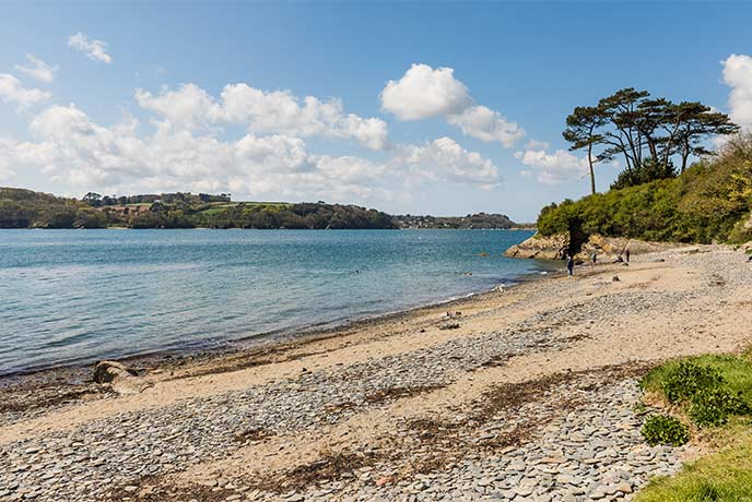 Looking across the sand and pebble beach at Porth Sawsen on the Helford River