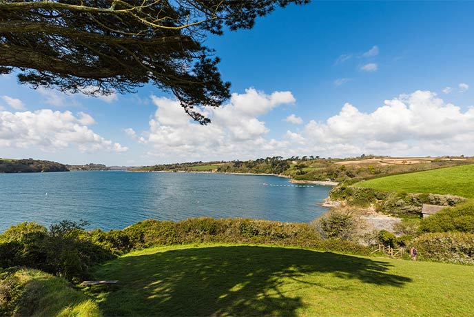 Looking across the rolling fields alongside the Helford River, with Porthallack Beach nestled in one of the dips