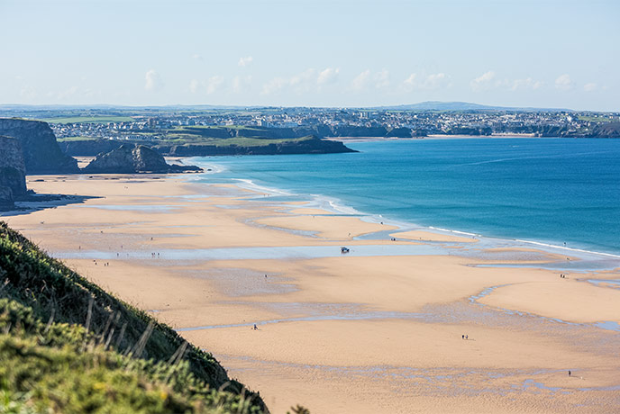 Looking out over the golden sands of Watergate Bay at Newquay in the distance