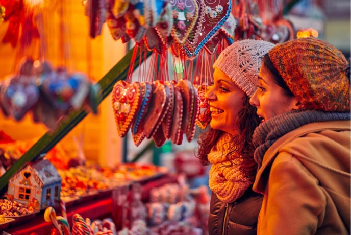 People looking at one of the festive stalls at Heartlands Christmas Market in Cornwall