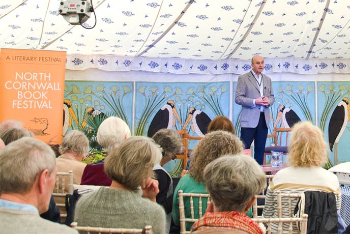 Someone giving a talk inside a tent at the North Cornwall Book Festival