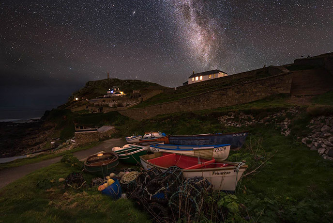 Looking up at Cape Cornwall at night with the night sky full of stars