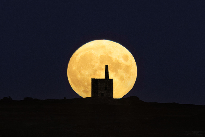 A huge harvest moon behind Ding Dong Mine in Madron