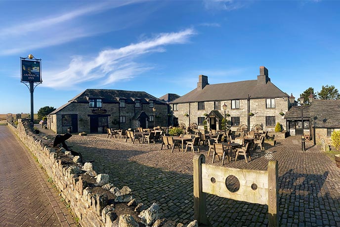 Looking across the courtyard full of tables at The Jamaica Inn in Cornwall
