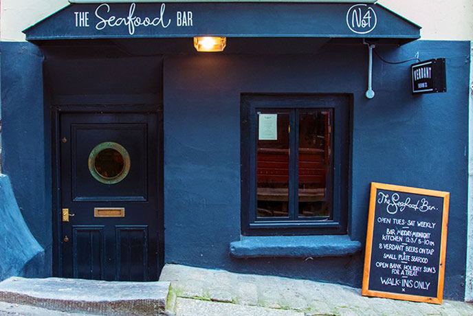The dark blue exterior of The Verdant Seafood Bar in Falmouth