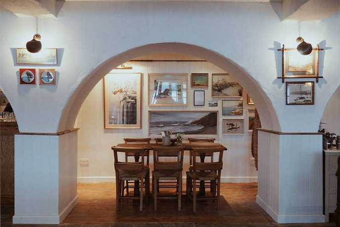 An archway and dining table at The Ferryboat Inn in Cornwall