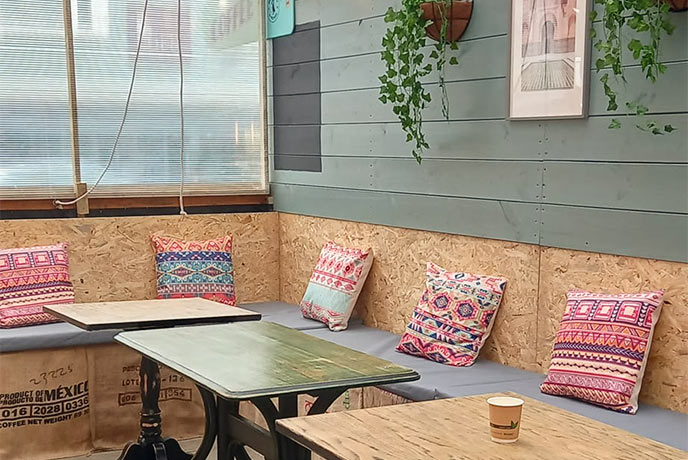 The simple wooden seating area at Roots Café in Cornwall