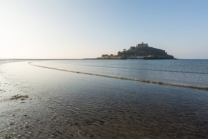 Looking across the beach at low tide at the castle of St Michael's Mount in Cornwall