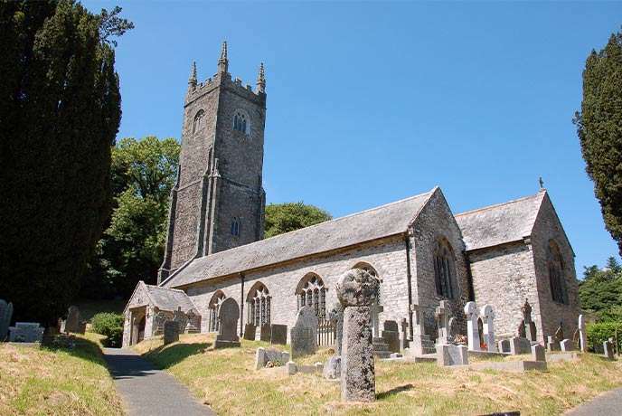 The pretty church and graveyard at St Nonna's Church in Cornwall