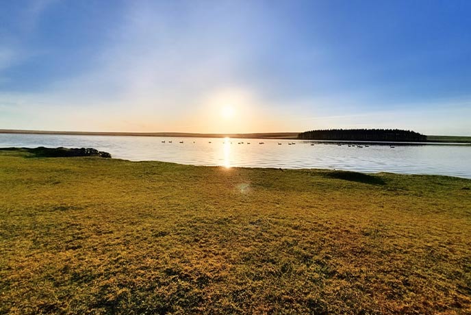 The sun setting behind Crowdy Lake in Cornwall