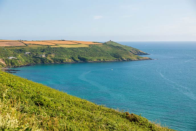 Looking across turquoise seas at Rame Head in Cornwall