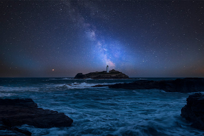 Godrevy Lighthouse at night backed by stars