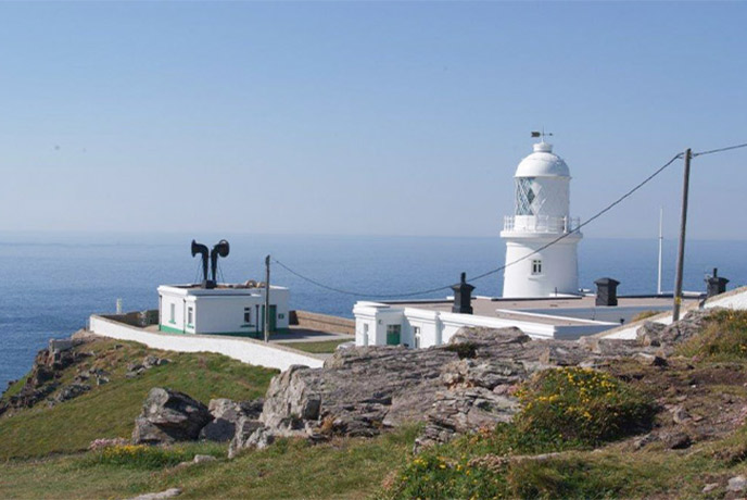 The white-washed Pendeen Lighthouse looking out to sea in West Cornwall