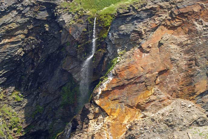The towering waterfall at Pentargon Waterfall in Cornwall