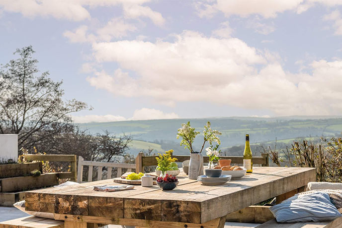 An outdoor dining table at Far View full of food and ready for some al fresco dining