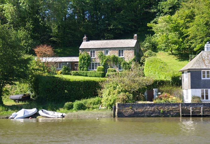 The classic cottage standing over the garden and looking down at the river