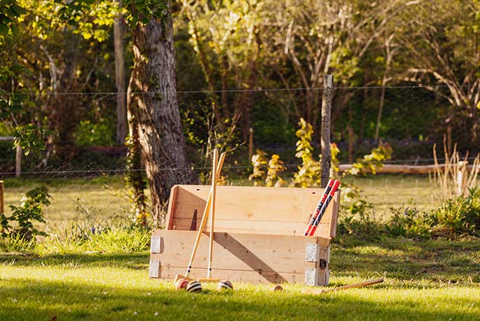 A wooden box full of lawn games at The Homestead in Cornwall