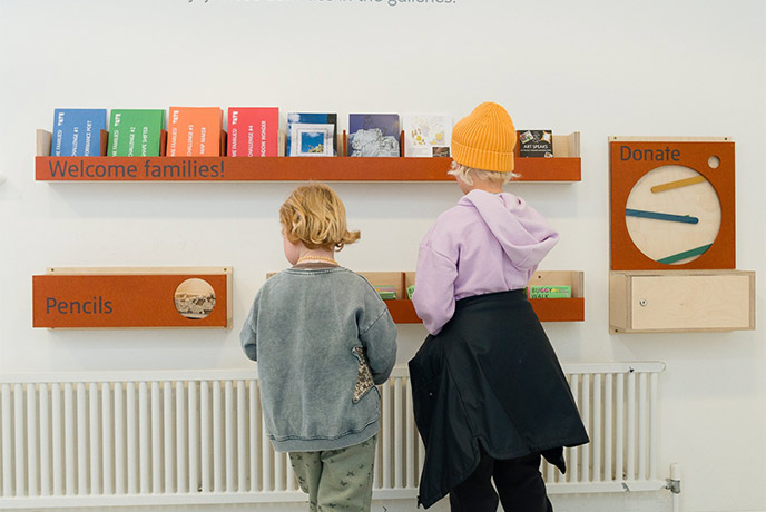 Two children looking at a wall full of activities for kids at Tate St Ives