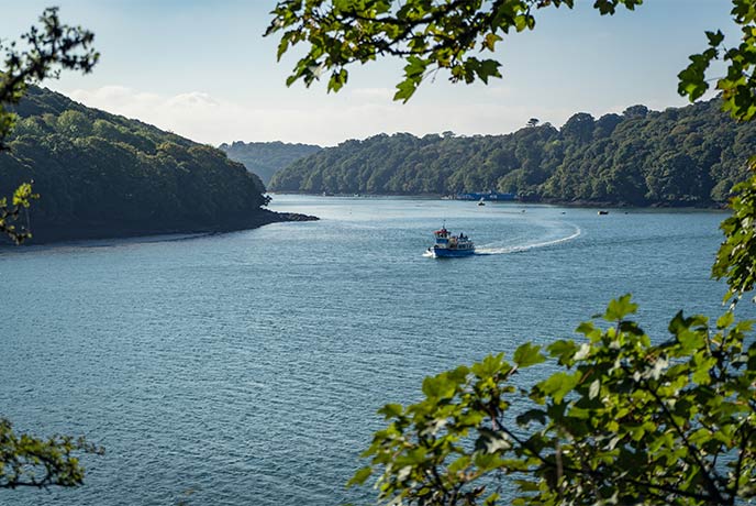 The Fal River Cruise boat sailing up Coombe Creek in Cornwall