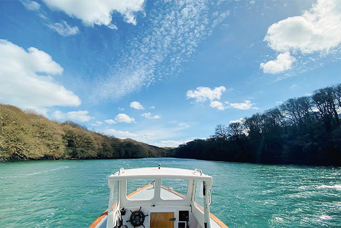 Looking out over a boat at the Helford with Helford River Cruises