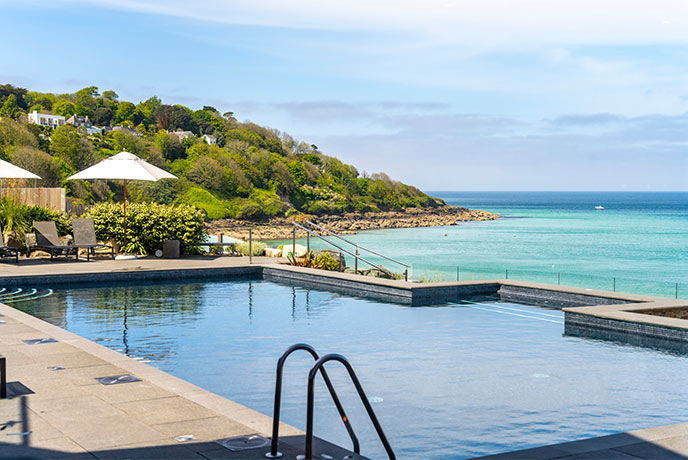 The beautiful outdoor swimming pool at C Bay Spa looking out over the sea