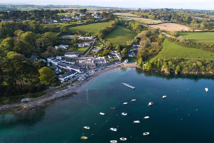 An aerial view of the pretty waterside village of Helford Passage on the Helford River