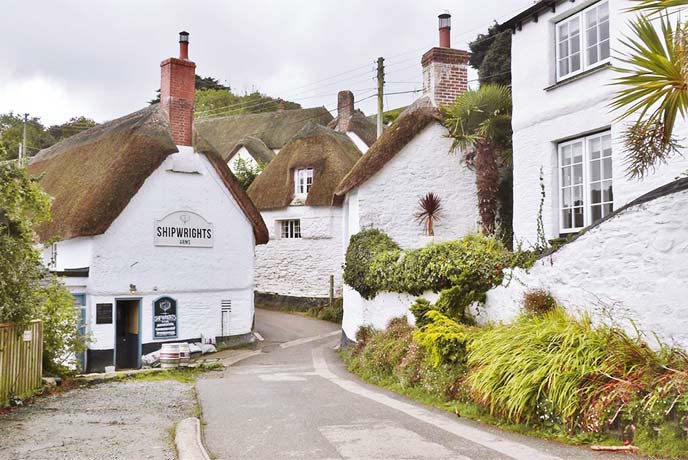 Pretty white, thatched cottages in Helford village in Cornwall