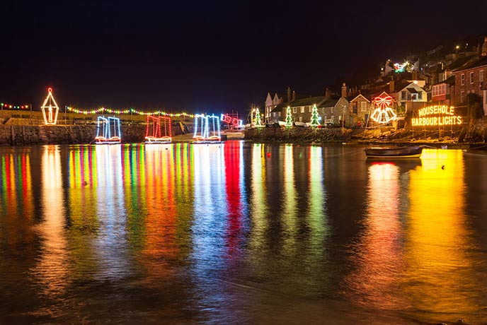 The famous Christmas lights in Mousehole harbour, the perfect backdrop for your New Year's Eve in Cornwall