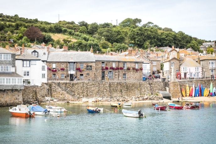 A line of pretty cottages looking over the harbour at Mousehole.