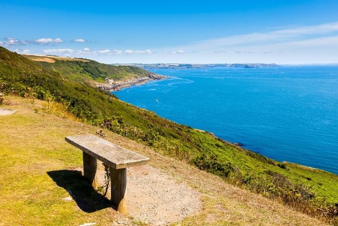 A bench at Rame Head with a stunning view of the Rame Peninsula