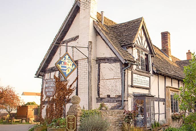 The Tudor style exterior of The Fleece Inn in the Cotswolds
