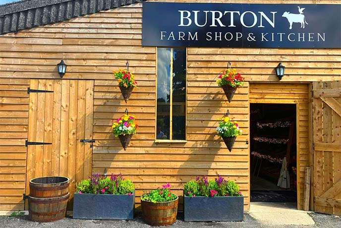 The wooden exterior of Burton Farm Shop in the Cotswolds