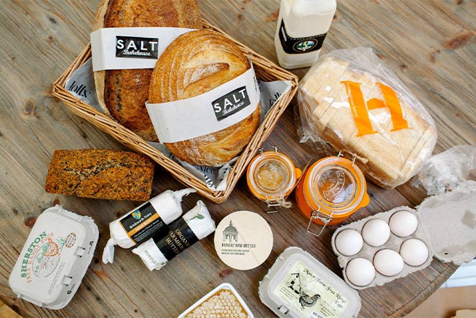 A selection of breads, fresh eggs and cheese at Jolly Nice farm shop in the Cotswolds