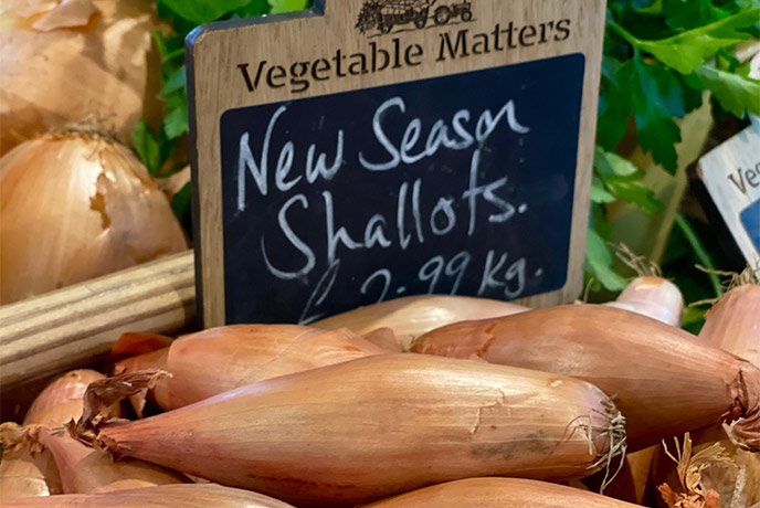 Fresh shallots on display at Vegetable Matters in the Cotswolds