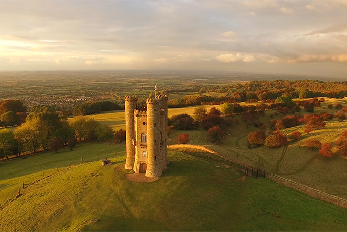 A bird's eye view of Broadway Tower in autumn with the countryside sweeping around