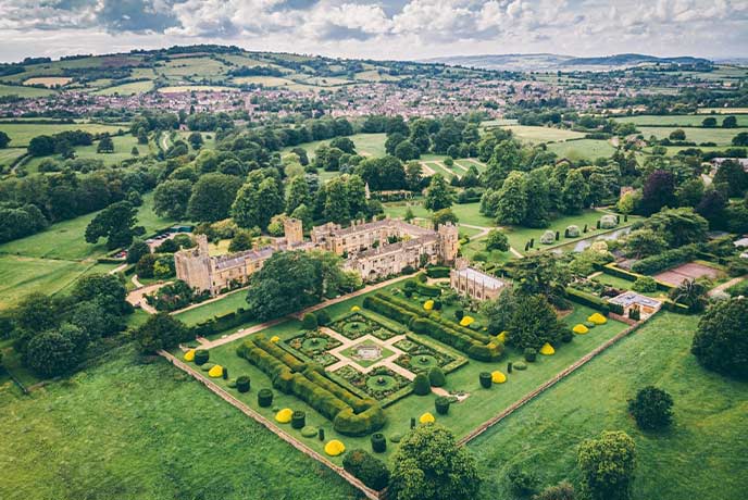 A bird's eye view of Sudeley Castle, its grounds and the surrounding Cotswolds countryside