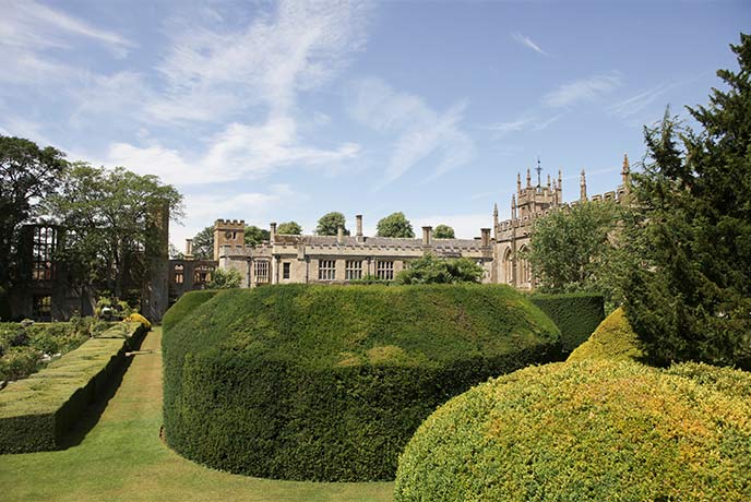 Looking over perfectly shaped hedges at Sudeley Castle in the Cotswolds