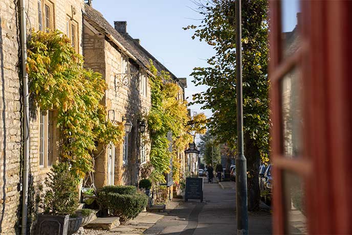 Looking down a street lined with honey-hued stone cottages in Stow-in-the-Wold