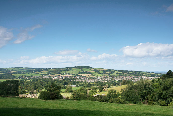 Looking across rolling hills at the pretty village of Winchcombe in the Cotswolds