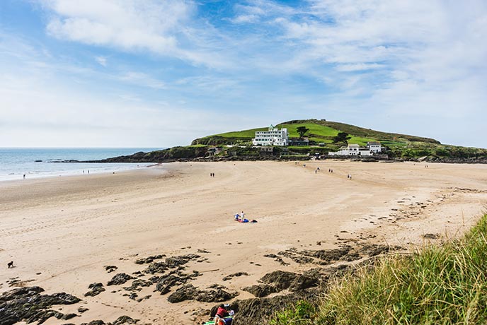 Looking across the golden sands of Bigbury-on-Sea Beach towards Burgh Island on the South West Coast Path