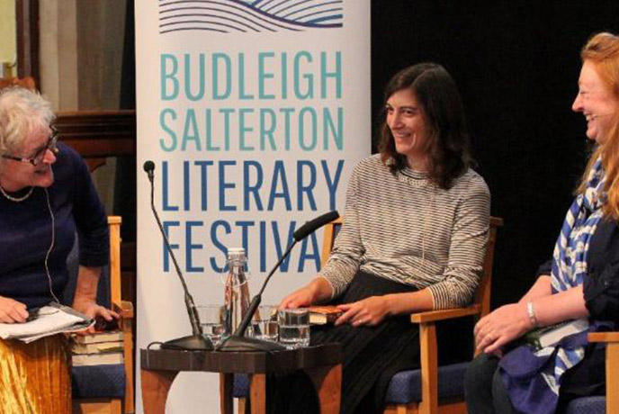 Three speakers laughing at the Budleigh Salterton Literary Festival