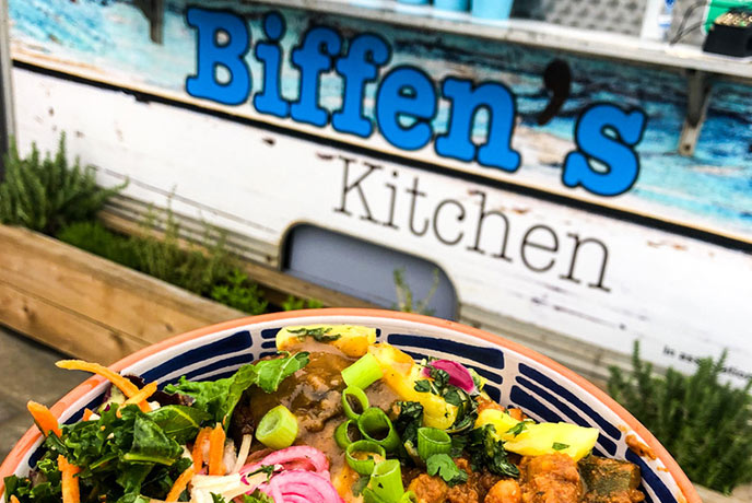 A plate full of thai food in front of the fabulous Biffen's Kitchen food van at Croyde beach