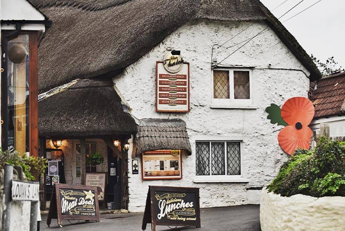 The white stones and thatched exterior of dog-friendly The Thatch in Croyde