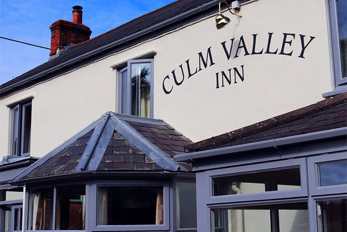 The Culm Valley Inn sign painted on the side of the inn