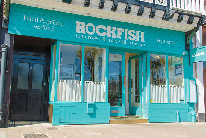 The bright blue exterior of Rockfish in Dartmouth, one of the best fish and chips in Devon