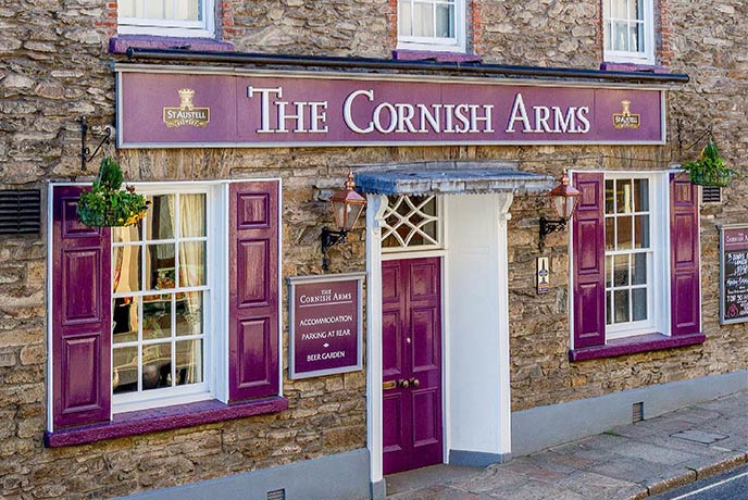 The brick exterior with striking purple signage of the Cornish Arms